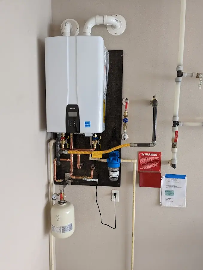 Professional plumber installing copper piping in a Cottage Grove home